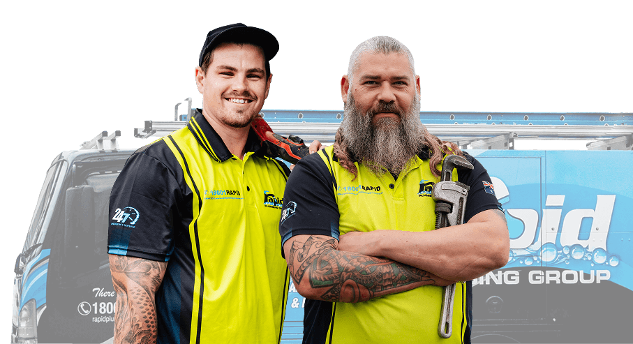 Two Rapid Plumbing Group tradespeople in front of a branded work van